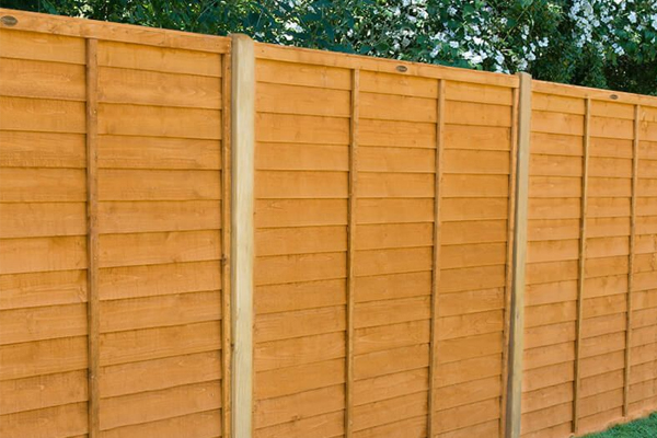a run of dip treated wooden fencing
