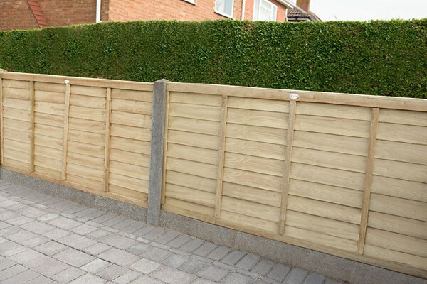 fence on driveway made up of driveway fence panels