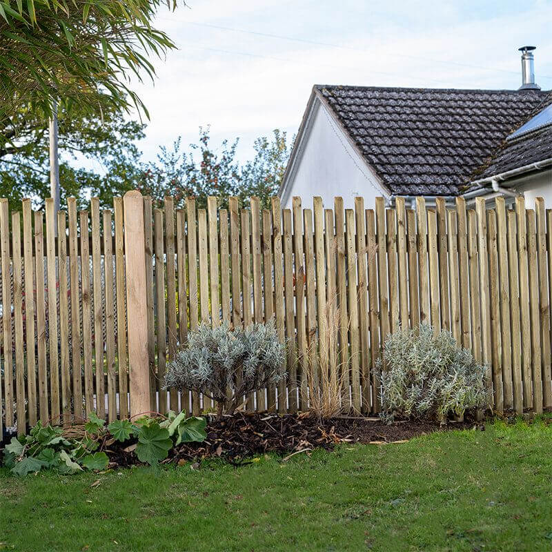 a contemporary picket fence - opting for standard panels over decorative ones will bring down fence installation costs