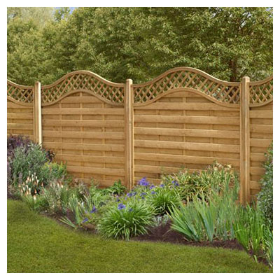 Forest 6x6 Paloma Fence Panel - Pressure treated fence panels with a wavy, diamond trellis top behind flowers and grasses