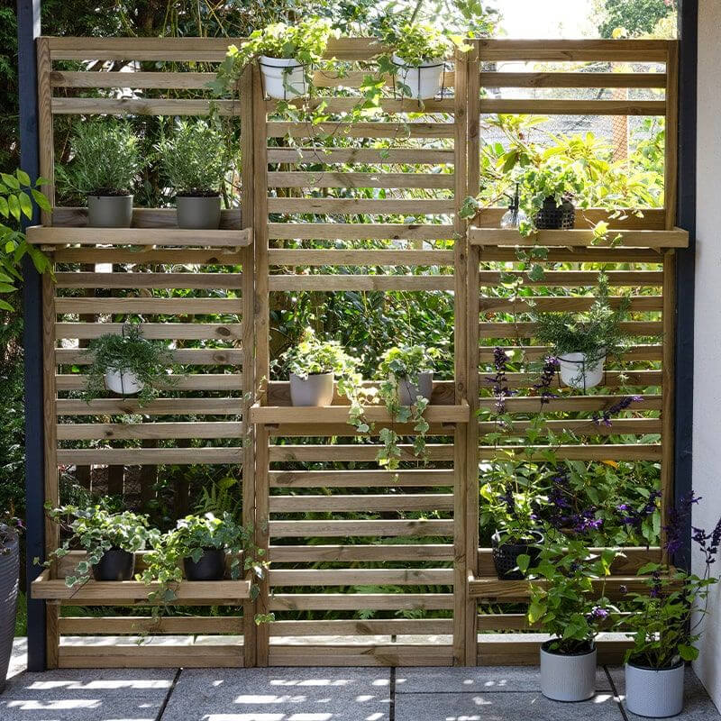 a living wall made from 3 tall wall planters - one of our decorative fencing ideas