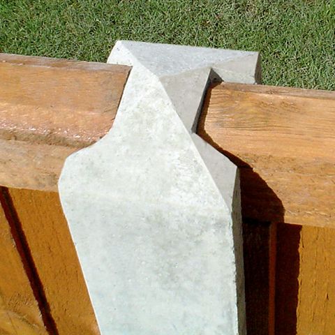 a close up view of a concrete fence post in situ