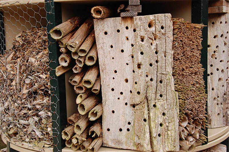a bug hotel - one of our decorative fencing ideas for the kids