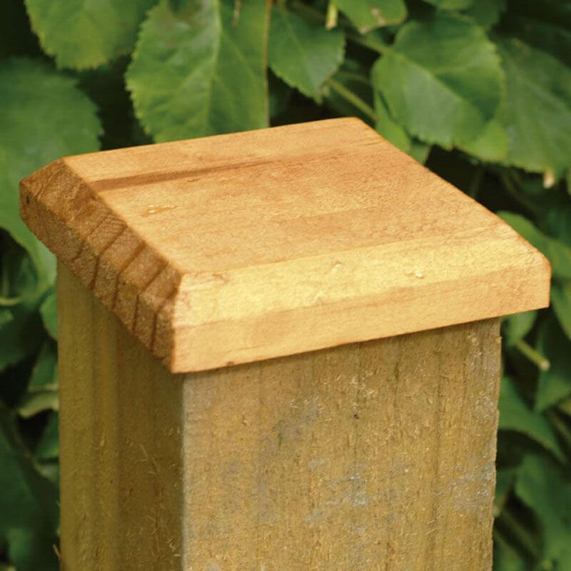 a wooden fence post cap