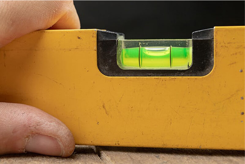 a spirit level is one of the tools you'll need to dig a fence post hole