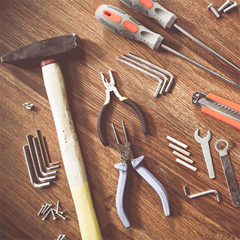 a selection of tools laid on a wooden floor