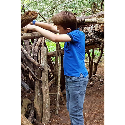 a boy building a den