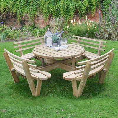 a circular wooden garden picnic table with picnic benches