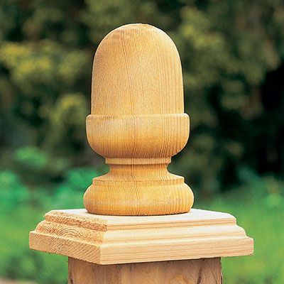 an acorn-shaped finial on top of a fence post cap
