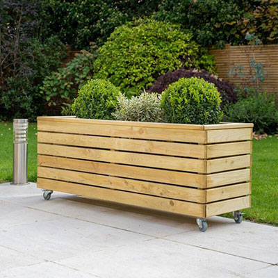A long wooden planter with a slatted design and wheels
