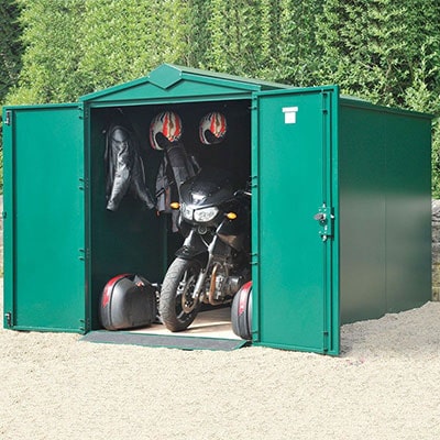 a very secure, green motorbike garage with its doors open to reveal a bike