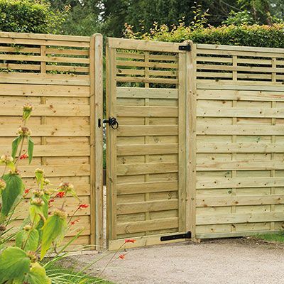 a modern garden gate and matching fence panels, all with slatted tops