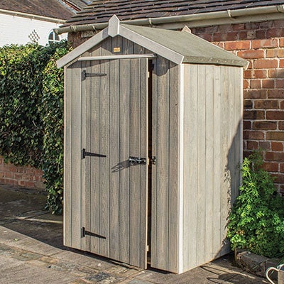 a grey, wooden tool shed with an apex roof and single door