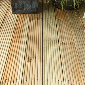 2 black plant pots on top of some wooden garden decking boards.