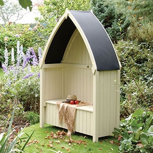 The cream Rowlinson Winchester Garden Arbour Seat 4x2, with its distinctive curved, black roof.