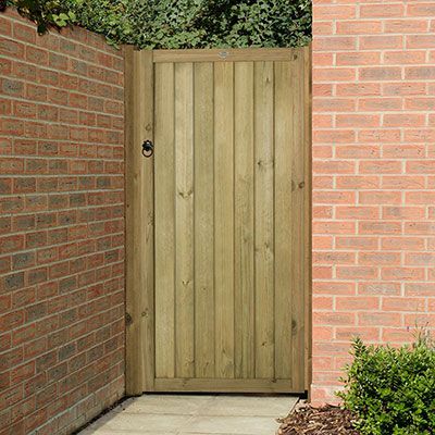 a wooden side gate made from vertical tongue and groove boards